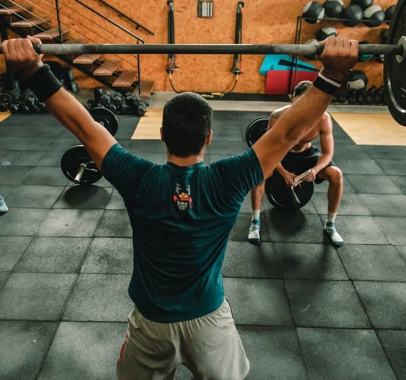 man lifting a barbell
