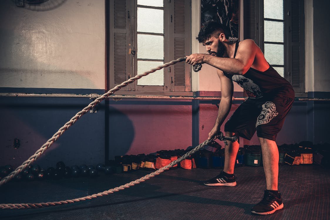 man swinging ropes