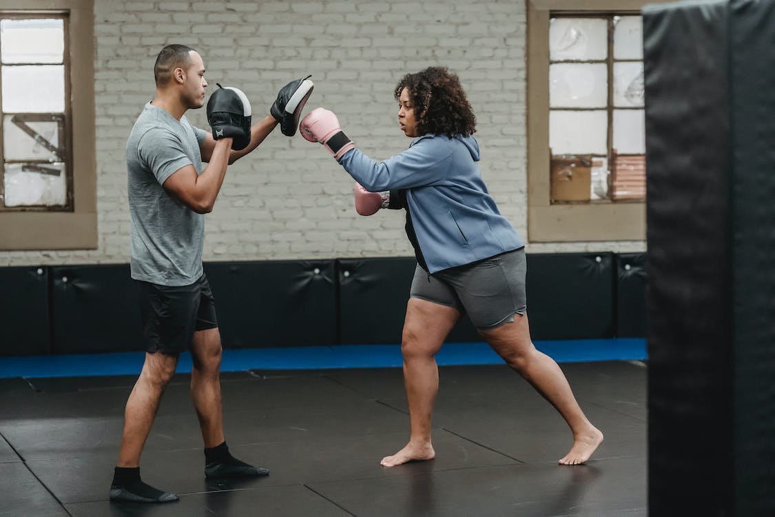 lady working with personal trainer